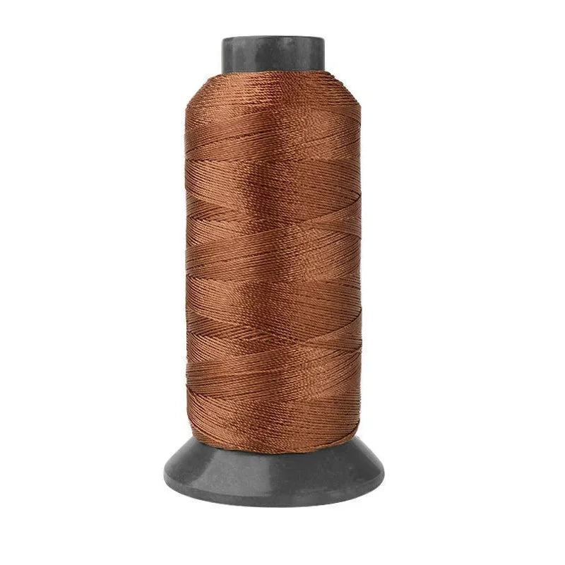 A spool of heavy-duty brown nylon sewing thread for upholstery and denim.