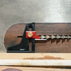 A precision aluminum height setting gauge is shown resting on a wooden table surface.