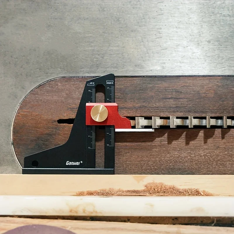 A precision aluminum height setting gauge is shown resting on a wooden table surface.