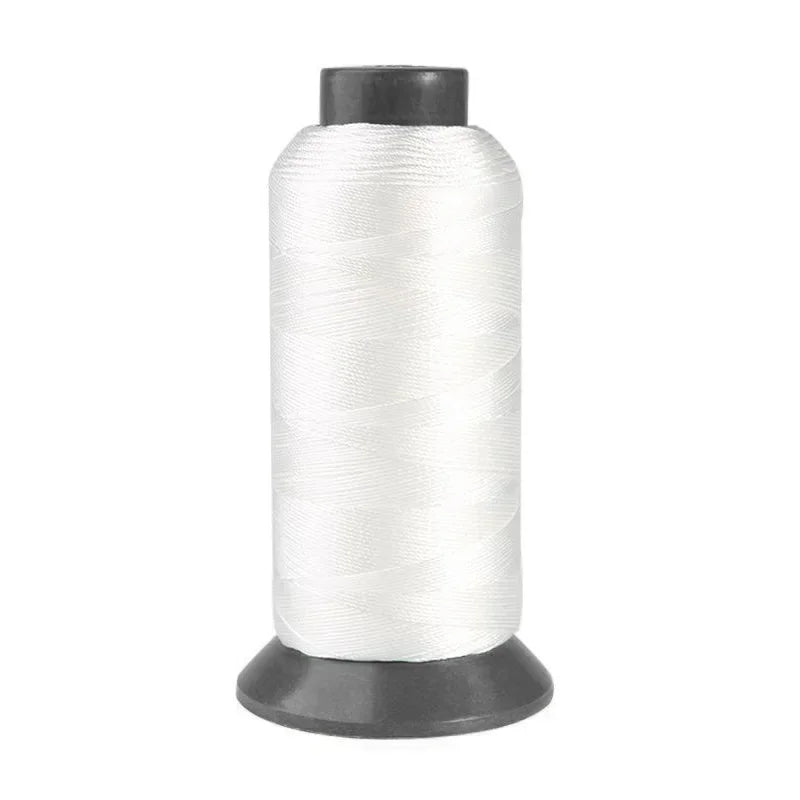 Spool of white heavy-duty nylon sewing thread for upholstery and denim
