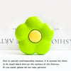 A bright lime green flower-shaped phone grip stand with small black dots on the surface.