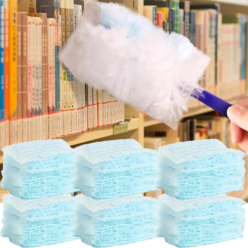 A hand holds a white microfiber duster refill, with several light blue microfiber cleaning cloths visible in the foreground.