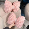 Pink bowknot car neck pillow with lumbar support shown in a car seat
