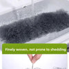 A close-up of a gray microfiber duster being used to clean a sink, highlighting its fine weave.