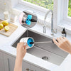 A hand is using a 3-in-1 bottle cleaning brush set with long handles to clean a kitchen sink.