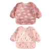 Pink waterproof long-sleeve baby bibs with a rainbow pattern and adjustable fit
