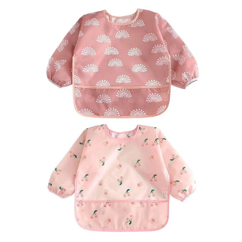 Pink waterproof long-sleeve baby bibs with a rainbow pattern and adjustable fit