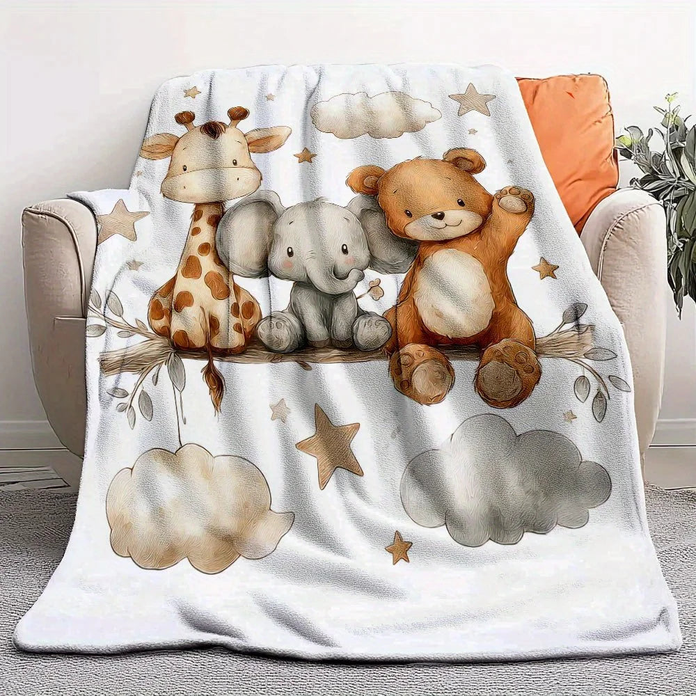 A cozy flannel blanket featuring illustrations of a giraffe, an elephant, and a teddy bear on a white background.
