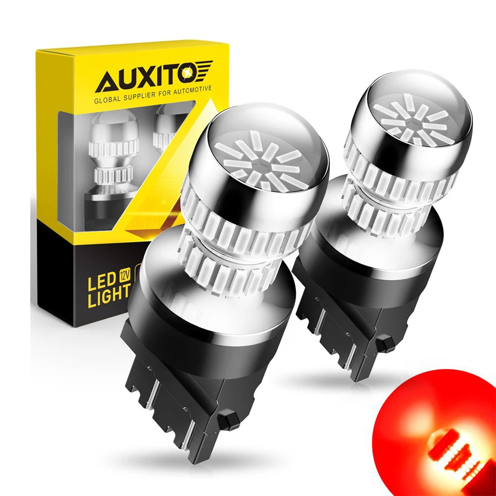 A box of AUXITO LED light bulbs for automotive use, showing various bulb types and a glowing red light.
