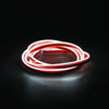 A flexible red and white LED strip light coiled in a circular shape against a dark background.
