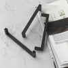 Matte black stainless steel cabinet pulls in a modern, angled design against a white marble background.