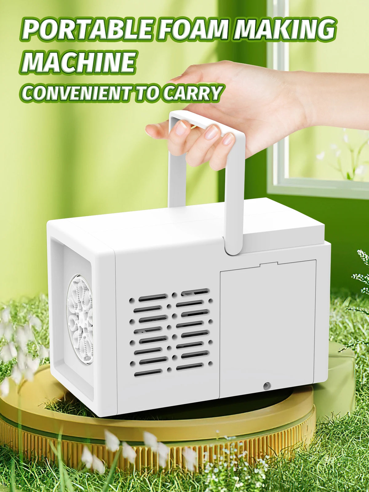 A white portable foam making machine is held by a hand, shown outdoors on green grass.