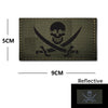 Dark olive embroidered patch featuring a skull and crossed swords design with reflective accents