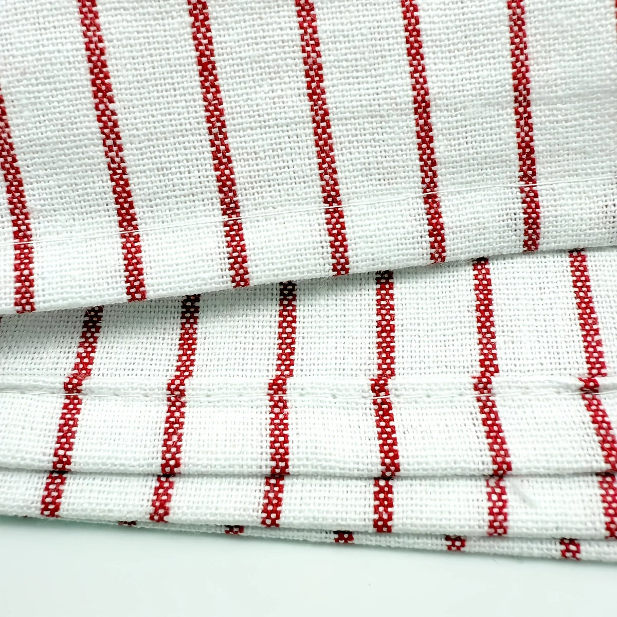 White and red striped lint-free kitchen dishcloths stacked together