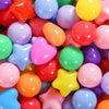 A close-up view of a large assortment of colorful, non-toxic ball pit balls in various bright colors.