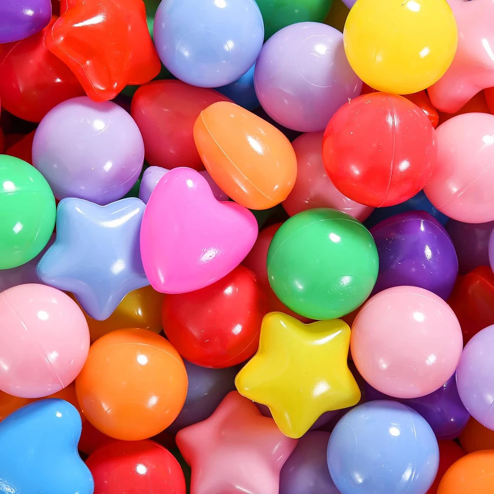 A close-up view of a large assortment of colorful, non-toxic ball pit balls in various bright colors.