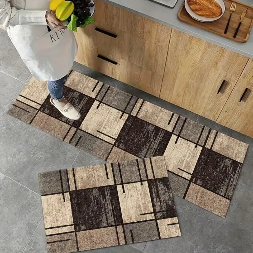 A rectangular modern checkered pattern floor mat with brown and beige tones is placed on a gray floor.