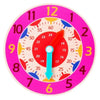 A pink wooden clock face with numbers and hands, showing the time.