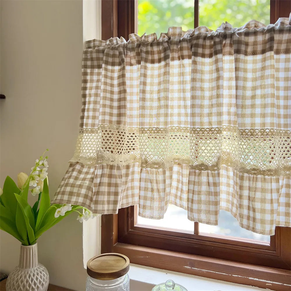 Beige gingham cafe curtain with crochet lace trim hanging in a window.