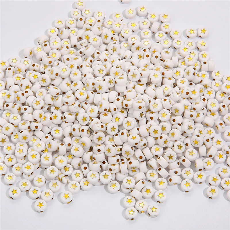 A pile of small white acrylic alphabet letter beads for jewelry making