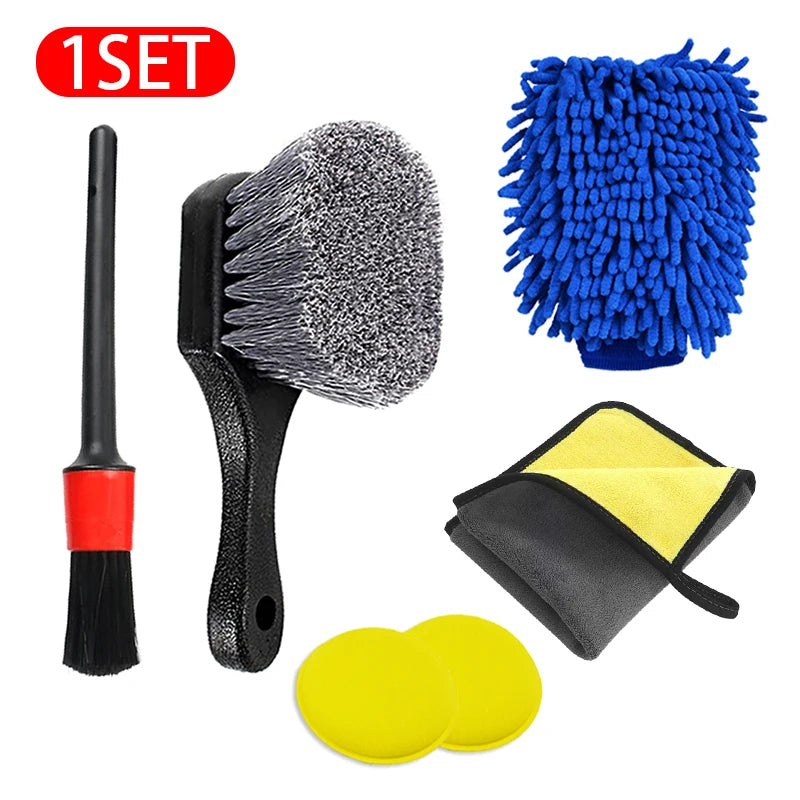 A set of black cleaning brushes, a yellow towel, and a black glove for car cleaning.