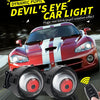A close-up of a red car headlight assembly with two rotating devil eye LED lights and a remote control.