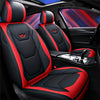 Black and red leather car seat covers with airbags, shown inside a vehicle cabin.