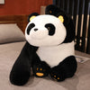 A black and white giant soft panda plush toy with long arms sitting on a gray surface.