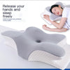 A person is resting their head on a butterfly-shaped memory foam pillow for neck pain relief.
