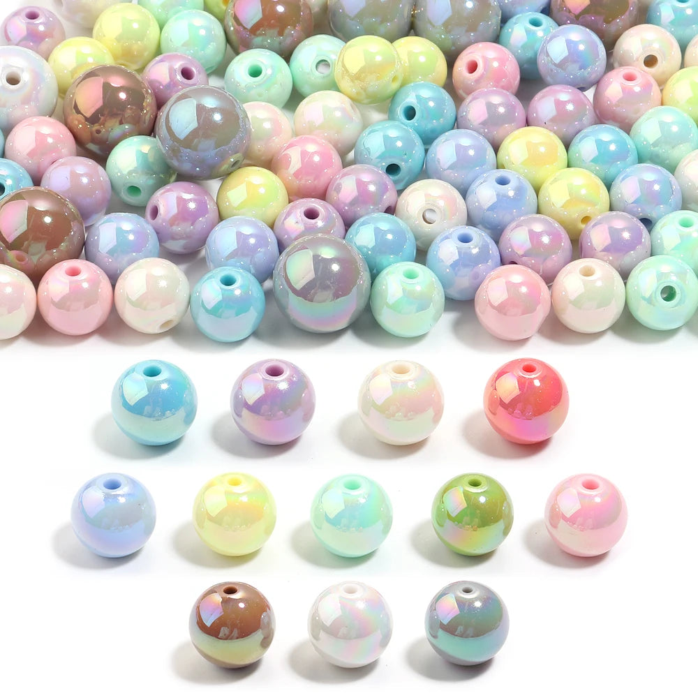 A collection of colorful acrylic round beads in various shades and finishes for jewelry making.