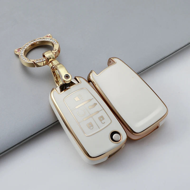 A gold-toned protective TPU key fob cover for a vehicle, shown against a light gray background.