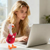 A woman is working on a laptop with a mini desk goose outfit set in front of her.