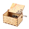 A hand-cranked wooden music box featuring a sun design and the text You Are My Sunshine.