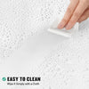 A hand wipes a white shower curtain liner with a cloth on a wet surface.