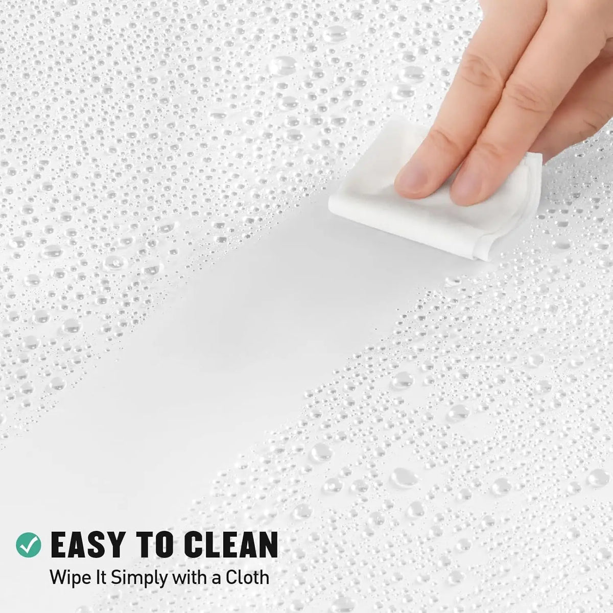 A hand wipes a white shower curtain liner with a cloth on a wet surface.