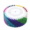 Colorful round pearl straight pins arranged in a circular pattern for sewing and crafts