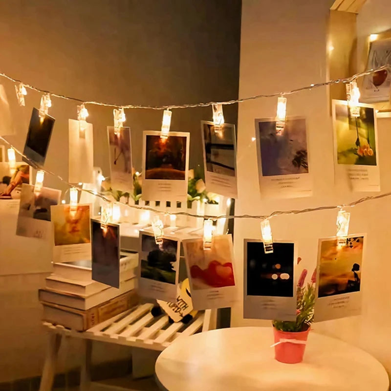 String lights displaying various photos and artwork in a gallery style