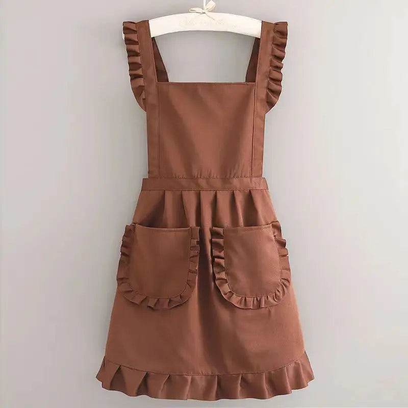 A brown Korean style cotton kitchen apron with adjustable neck straps and patch pockets displayed on a hanger.