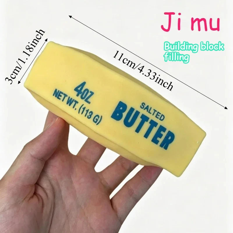 A yellow building block filling labeled salted butter is held in a hand with dimension measurements shown.