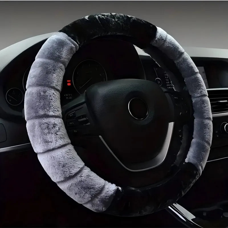 A close-up view of a black steering wheel covered with a thick, gray faux fur plush material.