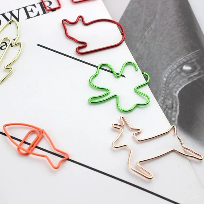 A collection of colorful decorative bookmarks shaped like animals, including a cat, bird, and deer, made from wire.