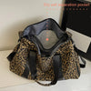 A leopard print weekender tote bag with a dry wet separation pocket shown open.
