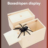 A wooden boxed or open display featuring a black spider inside.