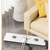 A white flat mop and bucket set with a silver handle is shown cleaning a floor in a living room setting.