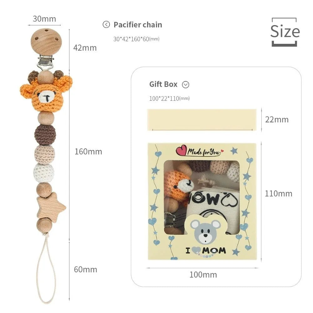 A wooden pacifier clip with a chain of crochet beads and a gift box featuring a baby theme.