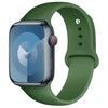 A dark green silicone sport band for an Apple Watch shown next to the watch.