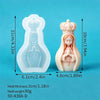 A white silicone mold of a praying girl with a crown is shown next to its measurement lines.