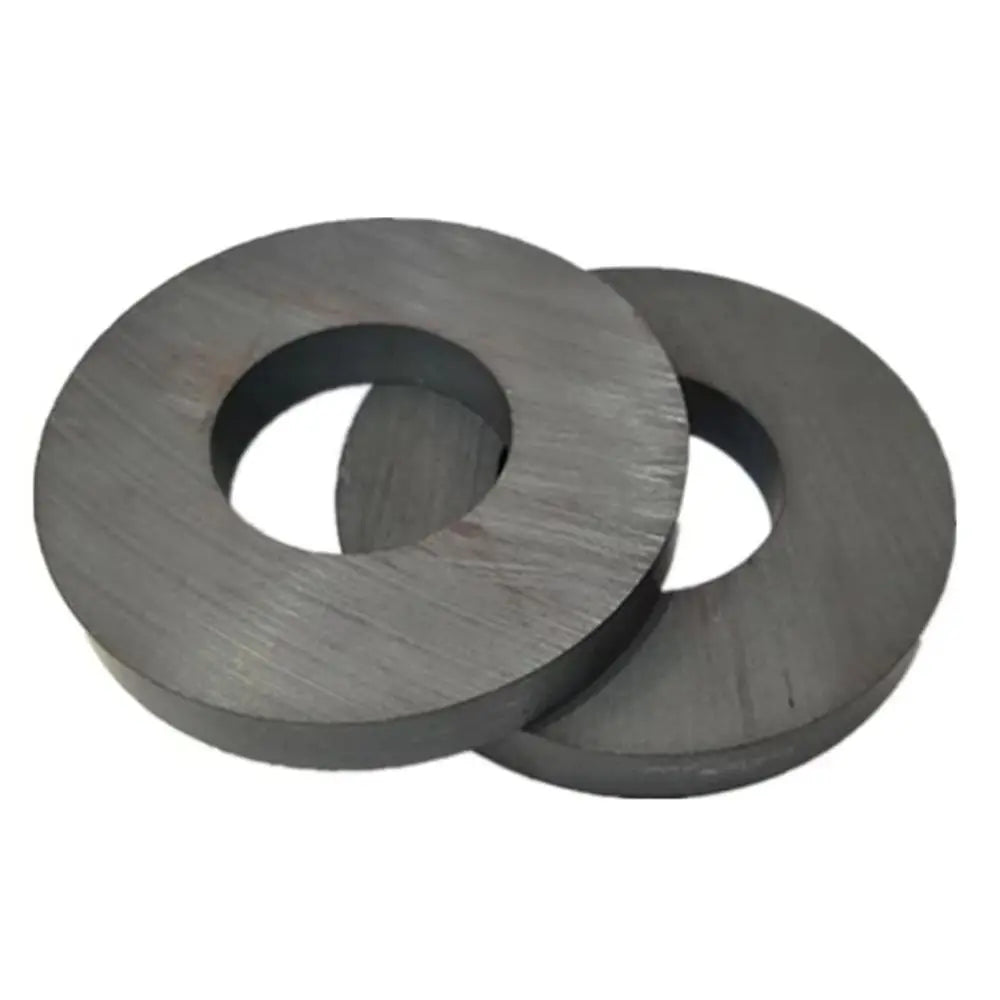 Two industrial-grade ceramic ring magnets, approximately 60mm in outer diameter, are shown.