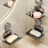 A wall-mounted soap dish with a suction cup and drain is shown in a modern bathroom setting.