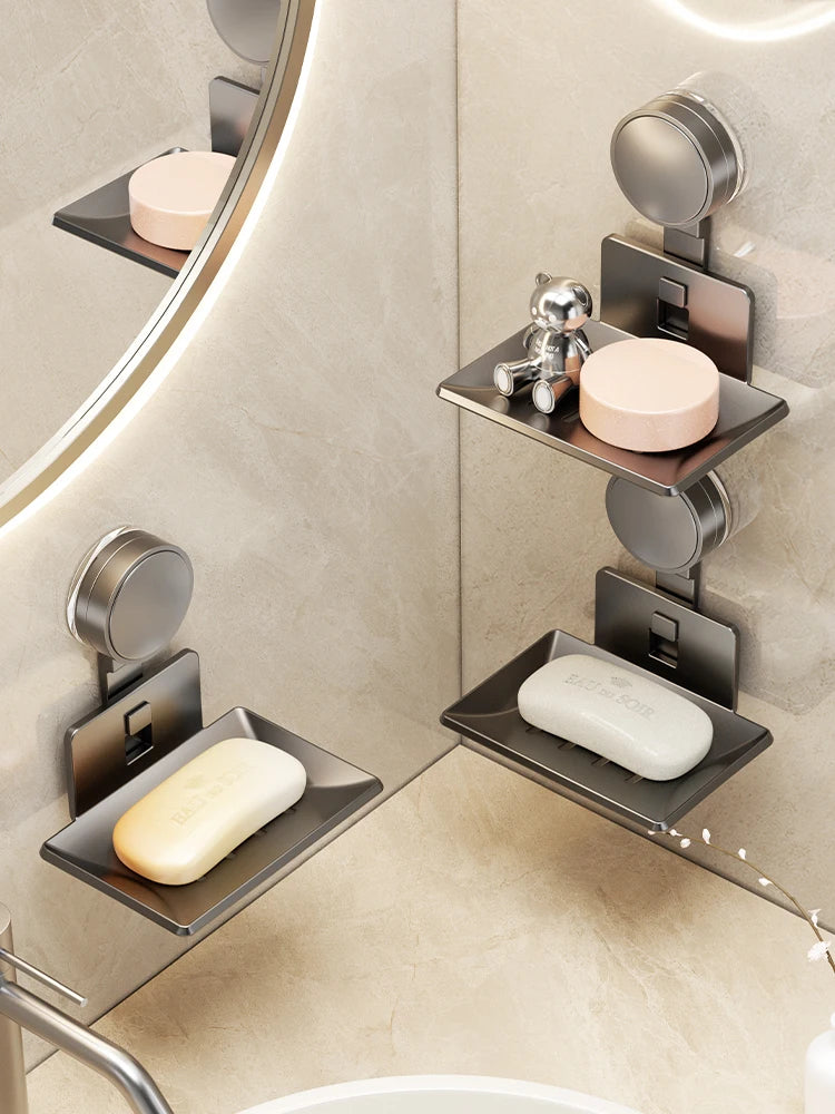 A wall-mounted soap dish with a suction cup and drain is shown in a modern bathroom setting.